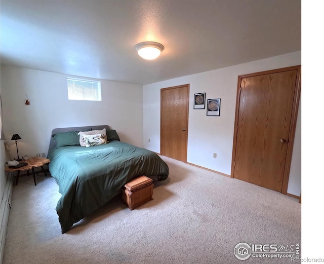 bedroom featuring carpet and baseboards