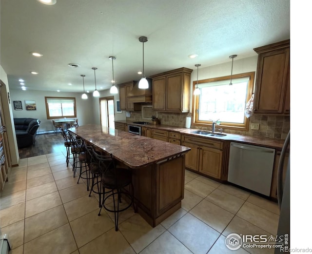 kitchen featuring a sink, a center island, dishwasher, and light tile patterned flooring