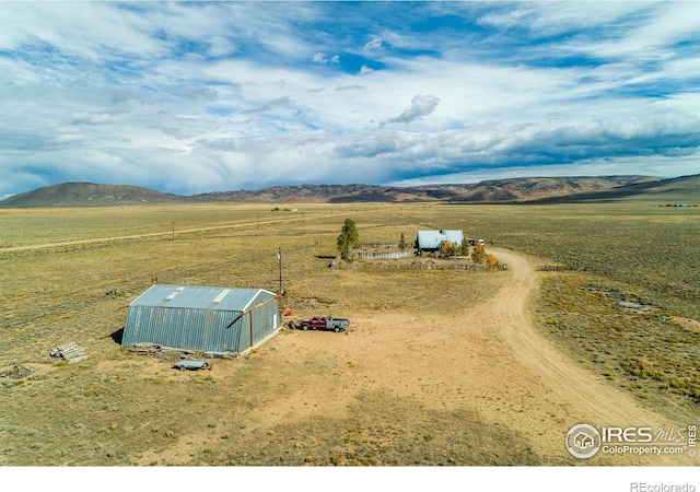 birds eye view of property featuring a mountain view and a rural view