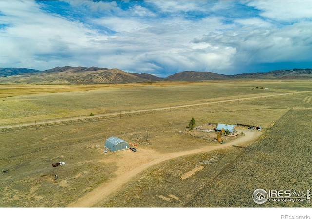 drone / aerial view featuring a mountain view and a rural view