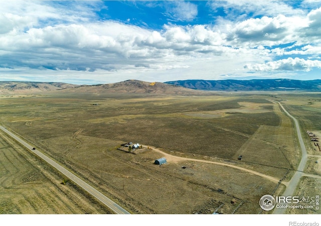 drone / aerial view featuring a mountain view and a rural view