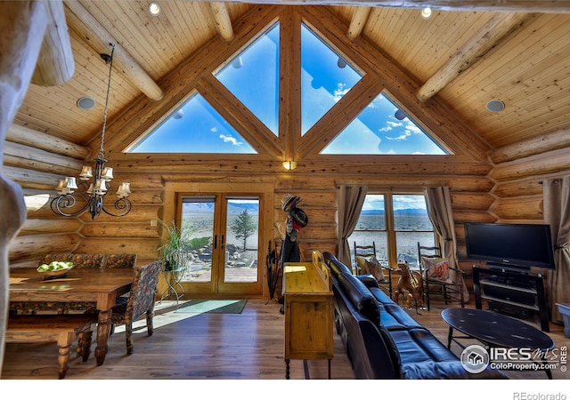 living room with high vaulted ceiling, a chandelier, and beamed ceiling