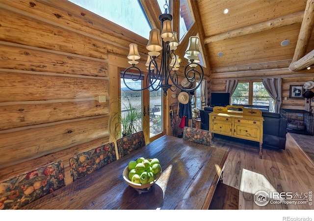 living room with wood ceiling, rustic walls, dark wood-type flooring, high vaulted ceiling, and a notable chandelier