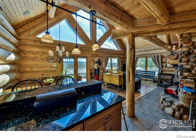 kitchen with wood ceiling, a fireplace, decorative light fixtures, and log walls