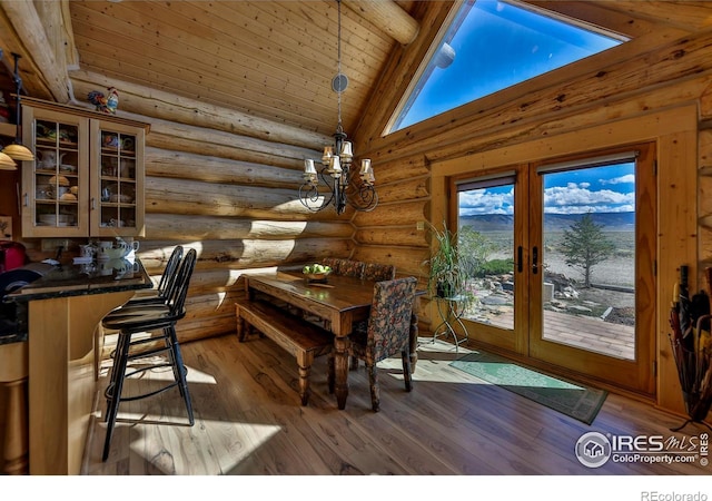 dining room with beam ceiling, hardwood / wood-style floors, french doors, and high vaulted ceiling