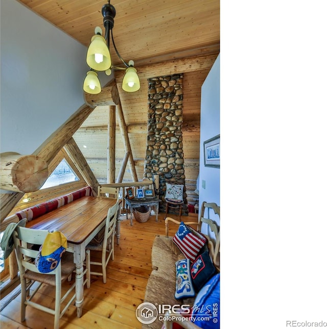 dining room featuring wood ceiling, vaulted ceiling, and light hardwood / wood-style floors