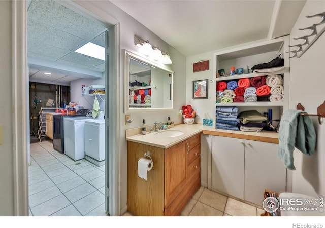 bathroom with vanity, independent washer and dryer, and tile patterned floors