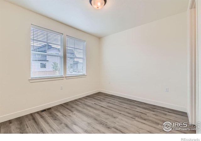 spare room with light wood-type flooring