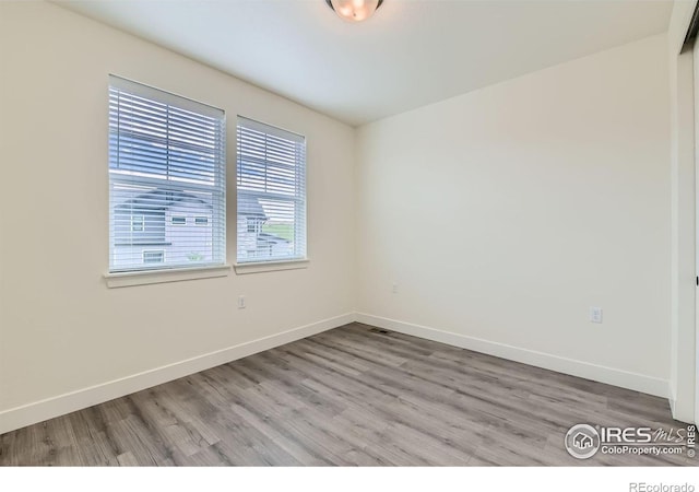 spare room with light hardwood / wood-style flooring