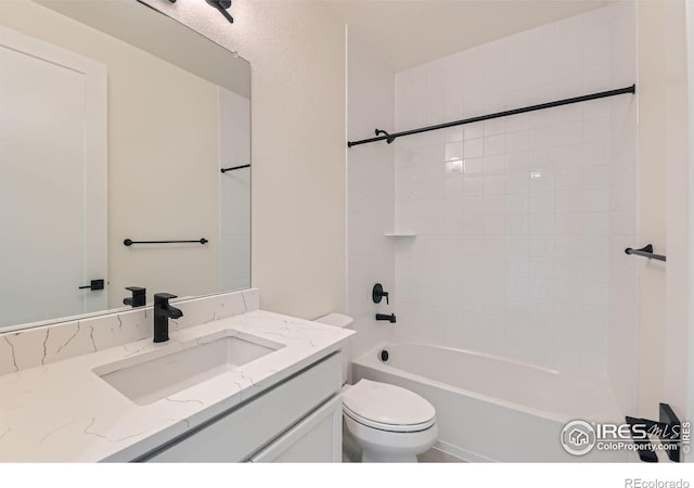 full bathroom with vanity, tiled shower / bath combo, and toilet