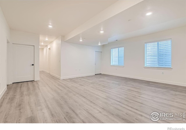 unfurnished room with light wood-type flooring