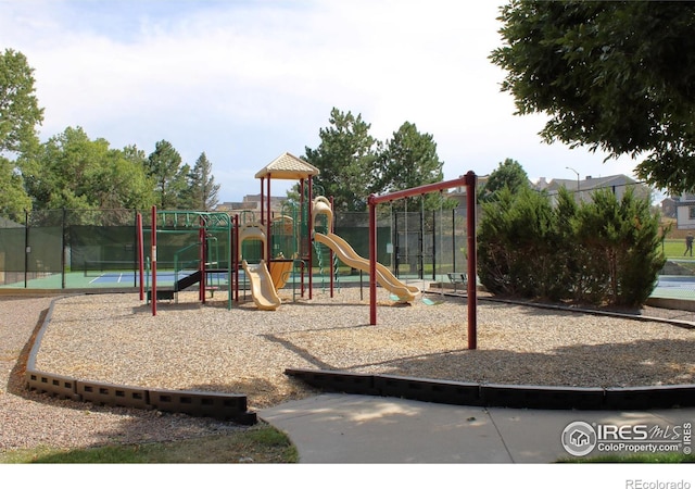 view of jungle gym with tennis court