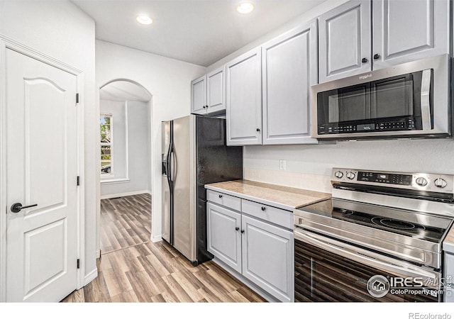 kitchen with stainless steel appliances and light hardwood / wood-style flooring