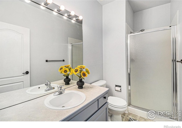 bathroom with toilet, tile patterned flooring, an enclosed shower, and vanity