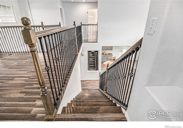 staircase with hardwood / wood-style flooring