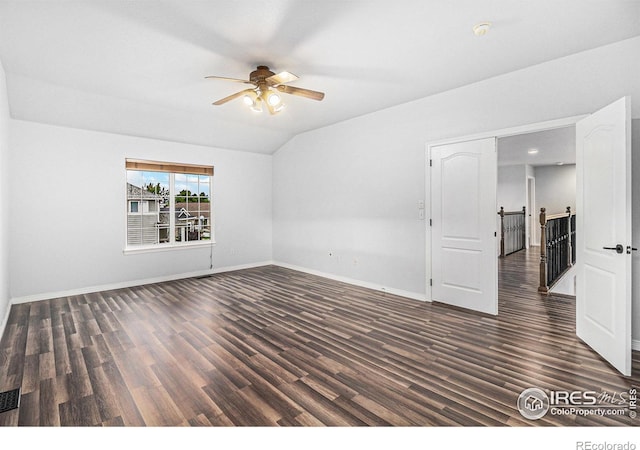 empty room featuring ceiling fan, dark wood-type flooring, and lofted ceiling