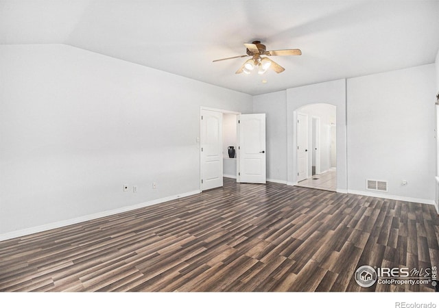 empty room featuring vaulted ceiling, ceiling fan, and dark hardwood / wood-style floors