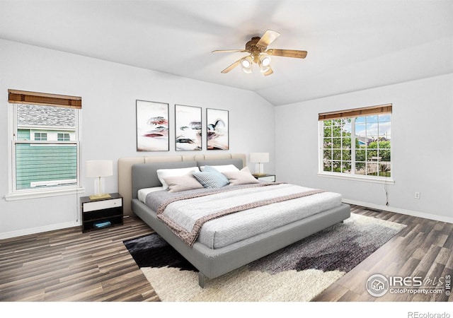 bedroom with ceiling fan, vaulted ceiling, and dark wood-type flooring