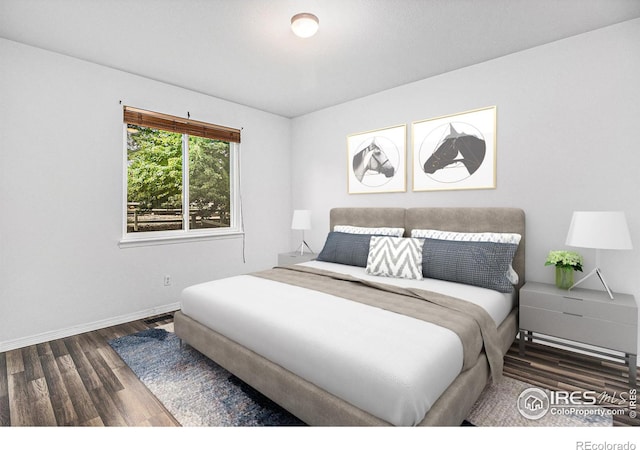 bedroom with dark hardwood / wood-style floors