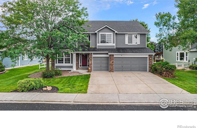 view of front of home with a garage and a front lawn