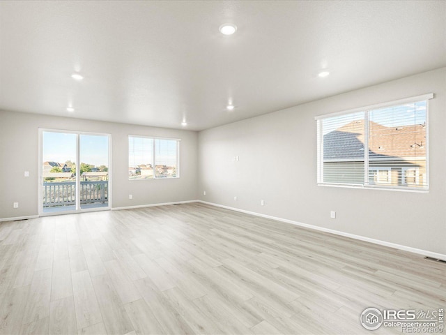 unfurnished room with light hardwood / wood-style flooring