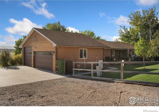 ranch-style home featuring a front yard and a garage