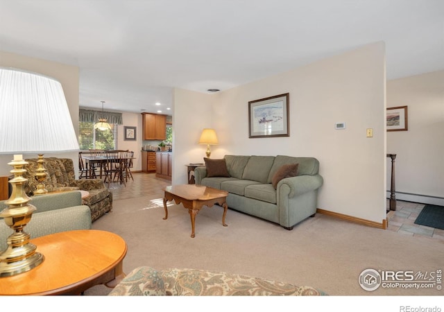 carpeted living room featuring a baseboard heating unit