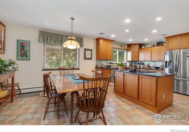 kitchen featuring a baseboard radiator, a center island, appliances with stainless steel finishes, and decorative light fixtures