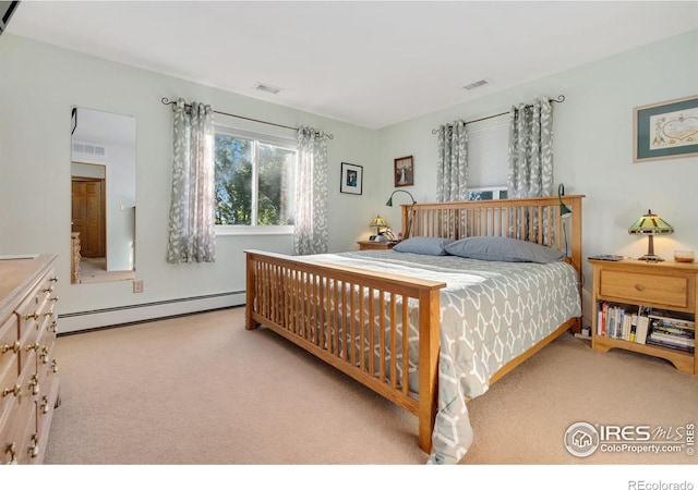 carpeted bedroom featuring baseboard heating