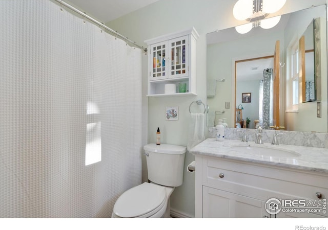 bathroom featuring vanity, toilet, and a wealth of natural light