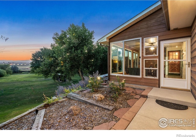 exterior space featuring a lawn and a sunroom