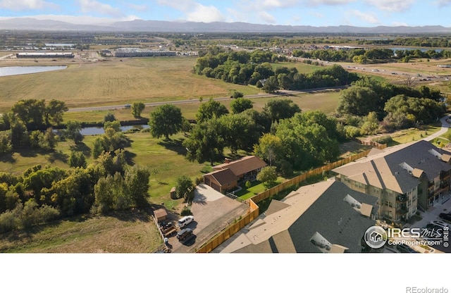 drone / aerial view featuring a water and mountain view