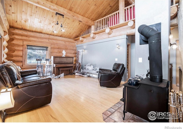 living room with a wood stove, rustic walls, beam ceiling, wood-type flooring, and wood ceiling