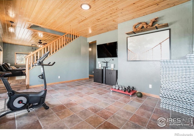 exercise area featuring tile patterned floors, ceiling fan, and wooden ceiling