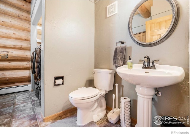 bathroom featuring toilet and baseboard heating