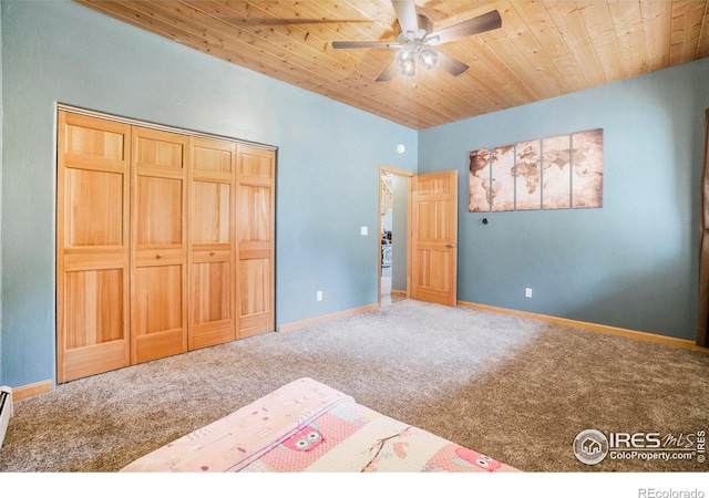 carpeted bedroom featuring ceiling fan, a closet, and wooden ceiling