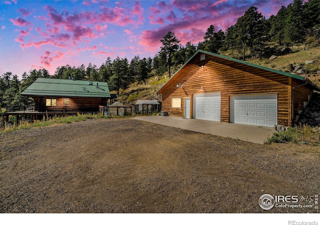 log cabin featuring a garage and an outdoor structure