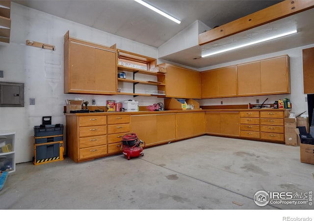 kitchen with electric panel and lofted ceiling