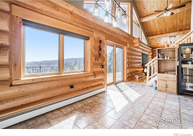 interior space with a mountain view, ceiling fan, baseboard heating, and log walls