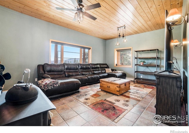 tiled living room featuring wood ceiling, ceiling fan, and a healthy amount of sunlight