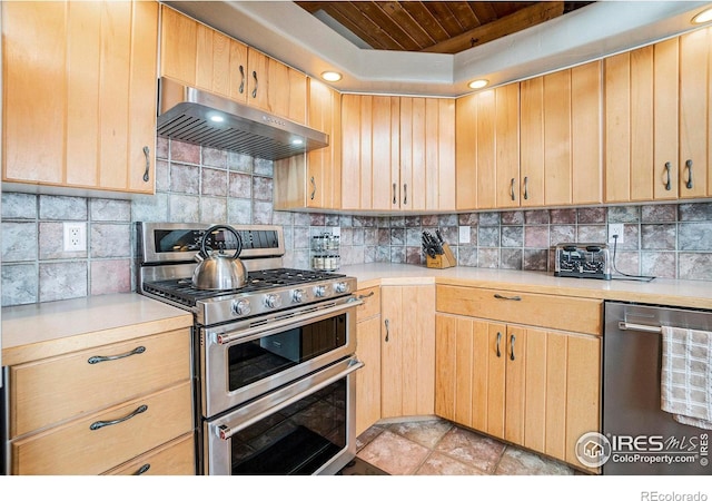 kitchen featuring light brown cabinets, stainless steel appliances, exhaust hood, decorative backsplash, and wood ceiling