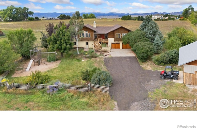 view of front of house featuring a rural view and a mountain view