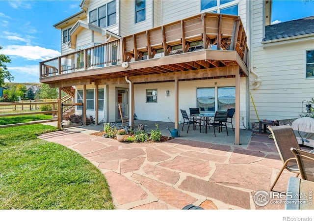 rear view of property featuring a patio and a balcony