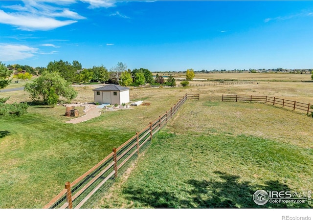 view of yard featuring a shed and a rural view