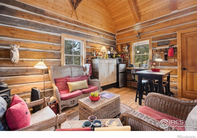 living room featuring wooden ceiling, high vaulted ceiling, rustic walls, a wealth of natural light, and light hardwood / wood-style floors