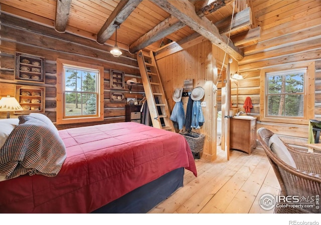 bedroom featuring log walls, beam ceiling, hardwood / wood-style flooring, and wooden ceiling