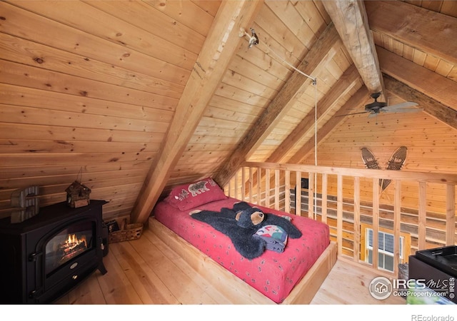 bedroom featuring vaulted ceiling with beams, wood walls, wood ceiling, and a wood stove