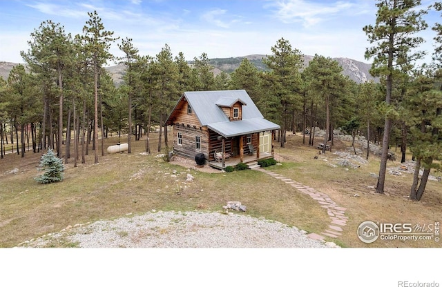 view of home's exterior featuring a mountain view and covered porch