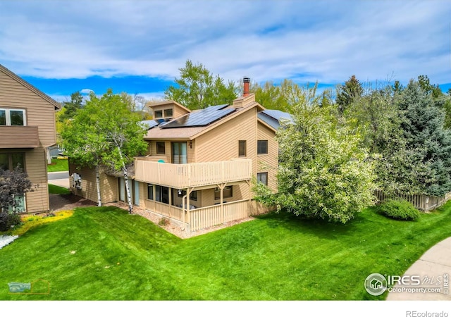 rear view of property featuring a lawn