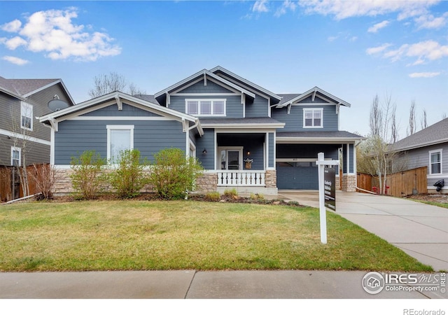 craftsman-style house with a front lawn, a porch, and a garage